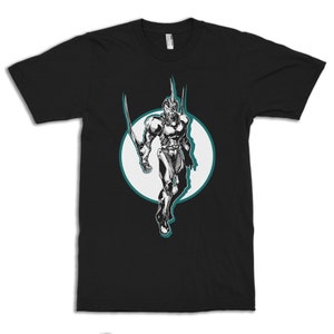 May include: Black t-shirt with a white circle graphic of a black and white character in a futuristic suit with a teal outline.