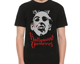 May include: Black t-shirt featuring a white graphic of a vampire with red blood dripping from its mouth. The text "Hollywood Vampires" is printed in red below the image.