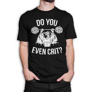 May include: Black t-shirt featuring a white graphic of a dragon lifting two 20-sided dice. The text "Do you even crit?" is printed below the dragon.