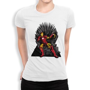 May include: White t-shirt with a graphic of Iron Man sitting on the Iron Throne from Game of Thrones. The Iron Throne is made of swords and Iron Man is holding the Infinity Gauntlet.