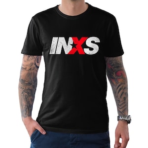 May include: Black t-shirt with a white and red distressed graphic of the word "INXS" with a star in the middle of the "X".