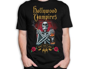 May include: Black t-shirt featuring a graphic of a skeleton in a coffin holding a bottle of whiskey and a cigarette. The text "Hollywood Vampires" is above the skeleton and "Bad as I am" is below. The graphic is surrounded by red roses.