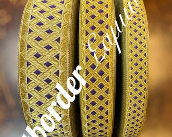 May include: Three spools of gold ribbon with a geometric pattern of purple diamonds. The ribbon has a textured appearance and is suitable for various craft projects. The text "Artborder Equiptns" is visible on the image.