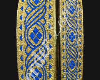 May include: Two spools of gold and blue trim with a geometric pattern. The trim is woven with a repeating design of blue diamonds and gold swirls.
