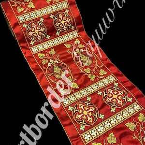 May include: Red fabric with gold and white embroidery. The fabric features a repeating pattern of crosses and floral designs.