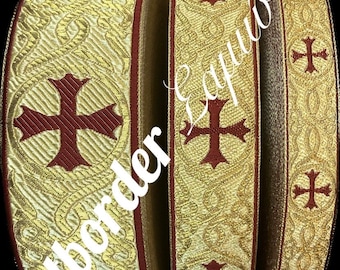 May include: Gold-colored ribbon with a repeating pattern of burgundy crosses. The ribbon has a textured, ornate design. The text "Artborder Equipts" is visible in white. The ribbon is likely used for religious or ceremonial purposes.