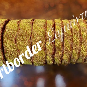 May include: A roll of gold and red trim with a floral pattern. The trim is approximately 1 inch wide.
