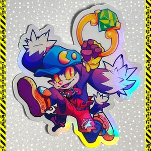 May include: Holographic sticker featuring a cartoon cat character in a dynamic pose. The cat wears a blue cap and red pants, holding a golden ring with a green gem. The sticker has a shiny, iridescent finish and a white border.