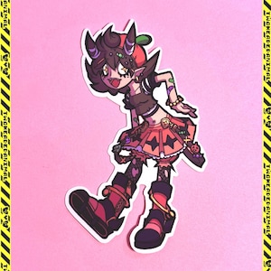 May include: A sticker featuring a cartoon character with dark hair, horns, and a mischievous expression. The character wears a crop top, skirt, and boots in shades of orange, black, and red. The background is pink.