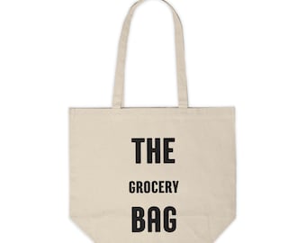 Könnte beinhalten: Eine beige Canvas-Tragetasche mit schwarzem Text, der "THE GROCERY BAG" lautet.