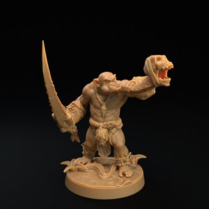 May include: A brown, detailed miniature figurine of an orc holding a sword in one hand and a severed head in the other. The orc is wearing a loincloth and has a fierce expression on its face.