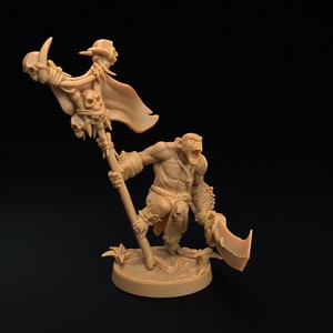 May include: A brown plastic miniature figurine of an Orc warrior holding a large axe and a staff with a skull and a banner. The Orc is wearing a loincloth and has a fierce expression on its face.