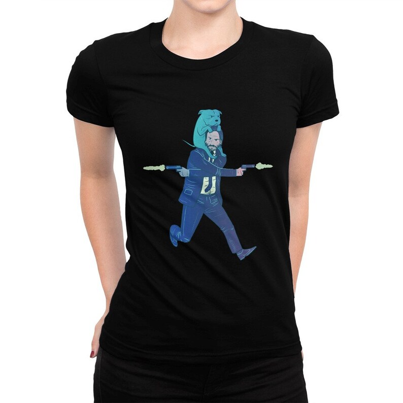 May include: Black t-shirt with a graphic of a man running with a dog on his shoulders, both holding guns. The man is wearing a suit and the dog is blue.