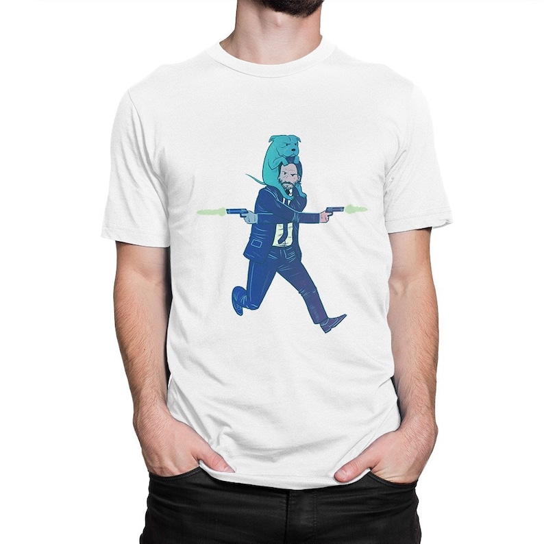 May include: A white t-shirt with a graphic of a man in a suit running with a dog on his shoulders. The man is holding two guns and the dog is blue.