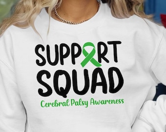 May include: White sweatshirt with the text "SUPPORT SQUAD" in black with a green ribbon above the text. Below the text is "Cerebral Palsy Awareness" in smaller black text.