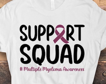 May include: White t-shirt with the text "SUPPORT SQUAD" in black with a purple ribbon above the word "SUPPORT". The text "#Multiple Myeloma Awareness" is below the words "SUPPORT SQUAD".