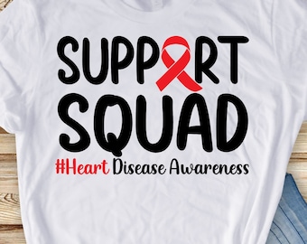 May include: White t-shirt with black text that reads "Support Squad" with a red ribbon above the word "Support". Below the text is a hashtag that reads "#Heart Disease Awareness".