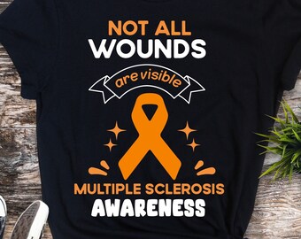May include: Black t-shirt with an orange ribbon and the text "Not all wounds are visible. Multiple sclerosis awareness."