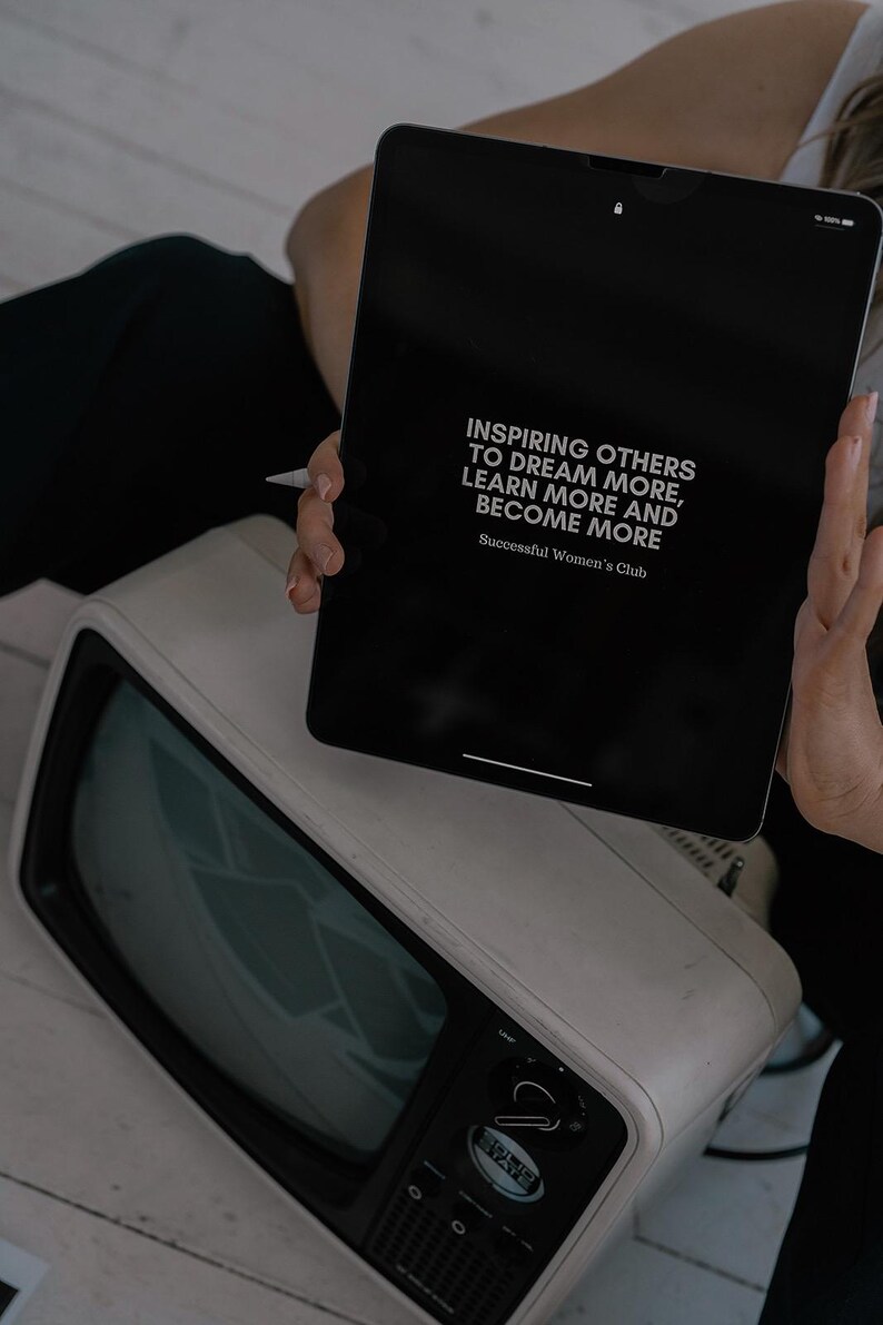 May include: A black tablet with a white background displaying the text "Inspiring others to dream more, learn more and become more. Successful Women's Club".