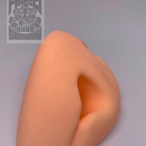 May include: A peach-coloured, 3D printed, realistic-looking nose prop. The nose is slightly angled and has a nostril opening.