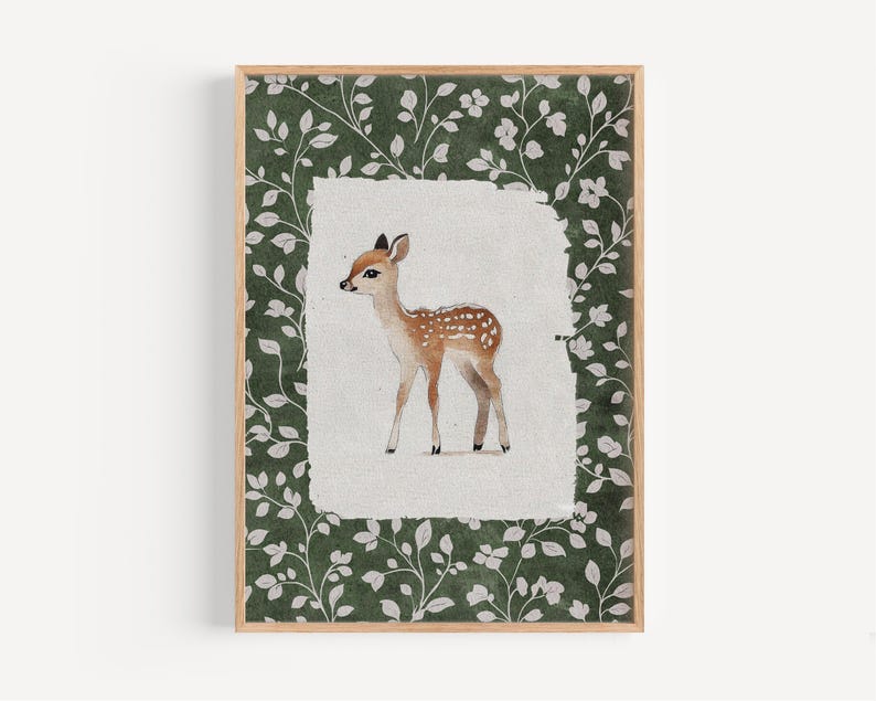 May include: A framed watercolor print of a fawn. The fawn is brown with white spots and is set against a white background. The frame has a green floral pattern.