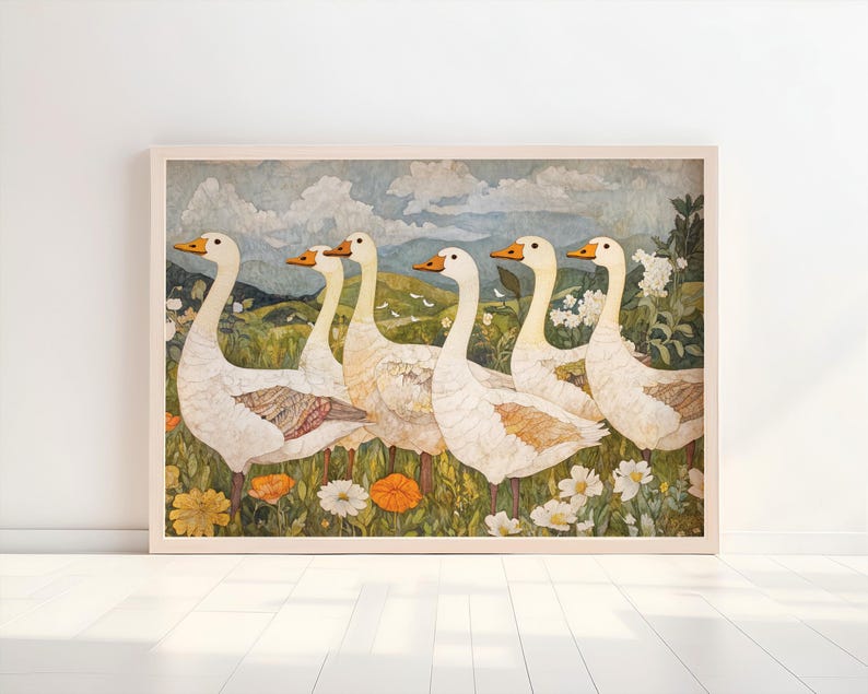 May include: A framed art print featuring six white geese with orange beaks and feet, standing in a field of wildflowers. The background shows rolling green hills, a blue sky, and clouds. The artwork has a vintage, watercolor style.