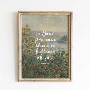 May include: A framed art print featuring a landscape painting with the text "In Your presence there is fullness of joy." The artwork has a vintage aesthetic with a gold-colored frame and a soft, muted color palette. Psalm 16:11 is also included.