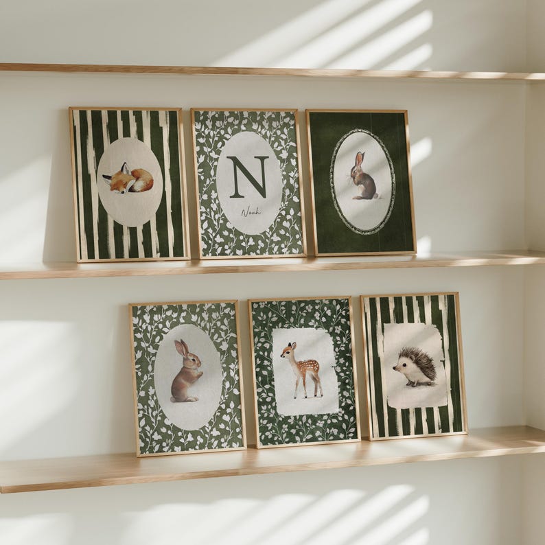 May include: Set of six framed art prints featuring woodland animals. Each print has a different animal: a fox, rabbit, deer, and hedgehog. The prints have a green and white color scheme with a wooden frame.