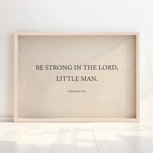 May include: A framed beige canvas print with the text "Be strong in the Lord, little man. Ephesians 6:10"