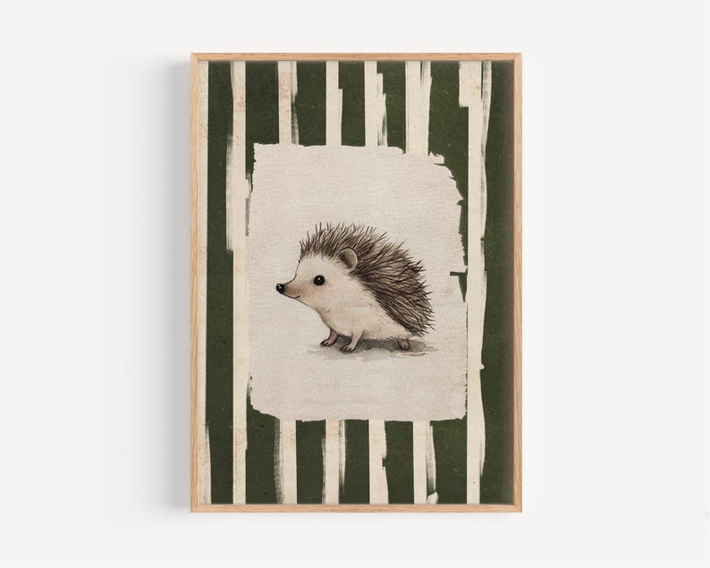 May include: A framed print featuring a watercolor illustration of a hedgehog. The hedgehog is depicted in soft, muted tones with a spiky back. The background has vertical green and white stripes, and the frame is a natural wood color.
