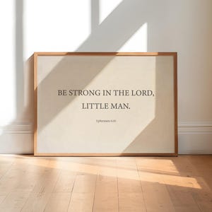 May include: A framed print with a beige background and the text "BE STRONG IN THE LORD, LITTLE MAN. Ephesians 6:10"