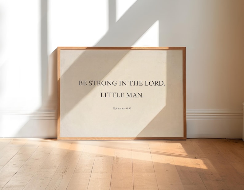 May include: A framed print with a beige background and the text "BE STRONG IN THE LORD, LITTLE MAN. Ephesians 6:10"