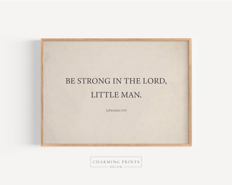 May include: A beige framed print with the text "Be strong in the Lord, little man. Ephesians 6:10" in black font.