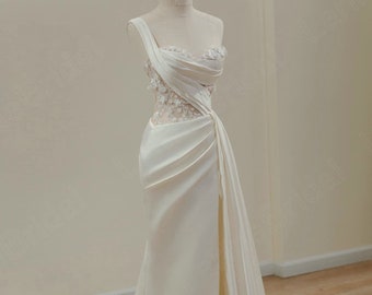 Luxurious satin wedding dress with thigh slit. Unique one-shoulder wedding dress. Lace-embellished satin wedding dress.