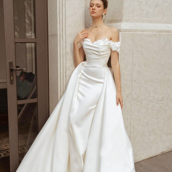 Luxurious off-the-shoulder satin wedding dress. Mermaid wedding dress with detachable train. Custom wedding dresses for brides.
