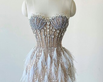 Gorgeous and luxurious crystal-embellished wedding dress. Unique feather wedding dress. Custom wedding dresses.