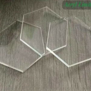 May include: Four clear acrylic hexagonal coasters. The coasters are stacked on top of each other.