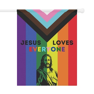 May include: A rainbow flag with the words "Jesus Loves Everyone" printed on it. A depiction of Jesus is in the center of the flag.