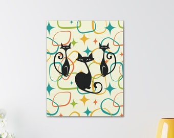 May include: Three black cats with white eyes are silhouetted against a background of colourful abstract shapes. The shapes are a mix of circles, ovals, and stars in shades of blue, green, orange, and yellow. The background is a light cream colour.
