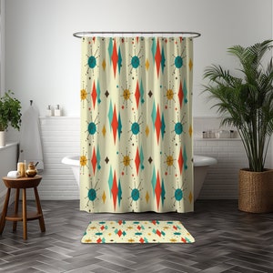 May include: A shower curtain and bath mat set with a retro mid-century modern geometric pattern. The pattern features teal blue, red, yellow, and white diamonds and stars on a cream background.