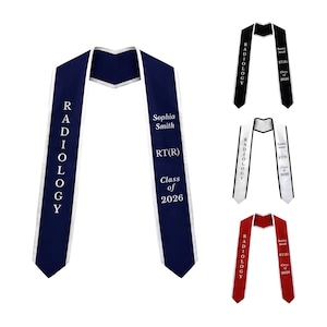 May include: Navy blue graduation sash with white text that reads "RADIOLOGY" vertically. The sash also includes the name "Sophia Smith", "RT(R)", and "Class of 2026". Additional sashes in black, white, and red are also shown.