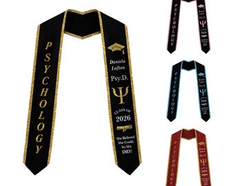 May include: Four graduation stoles in black, pink, blue, and maroon, each with gold glitter trim. The stoles feature the word PSYCHOLOGY, a graduation cap, the name Daniela Lofton, Psy.D., the Greek letter Psi, Class of 2026, and the text She Believed She Could, So She DID!