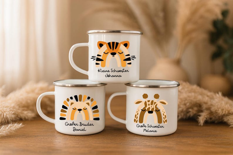 May include: Three white enamel mugs with silver rims, each featuring a colorful animal-themed rainbow graphic. The top mug shows a tiger with the text "Kleine Schwester Johanna". The bottom mugs show a hedgehog with "Gro&szlig;er Bruder Daniel" and a giraffe with "Gro&szlig;e Schwester Melanie".