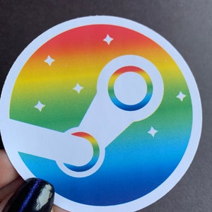 May include: A round sticker with a rainbow gradient background and a white Steam logo. The logo is a stylized letter 'C' with a circle around it. There are white stars scattered around the logo.