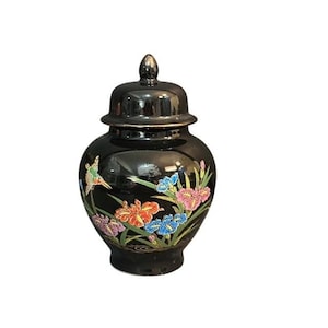 May include: A white ceramic mug with a black handle and the text "But First, Coffee" in a handwritten style. The mug is on a white surface. The mug is 4 inches tall.