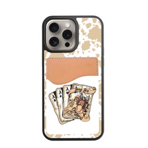 May include: A phone case with a black border, a tan cowhide pattern, and a brown leather cardholder. The case features a playing card design with a cowboy riding a horse, the words "Long Live Cowgirls."