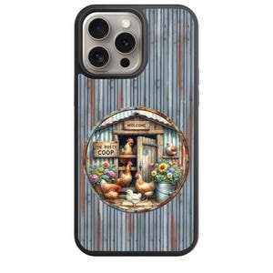 May include: A black phone case with a watercolor design. The case features a rustic chicken coop scene with chickens, flowers, and the text "THE RUSTY COOP" and "WELCOME". The background has a corrugated metal texture.
