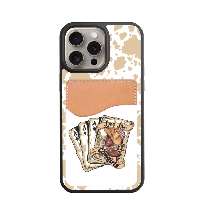 May include: A black phone case with a tan cowhide pattern and a tan leather cardholder. The case features a graphic of playing cards with a cowboy hat and the text "Long Live Cowgirls."