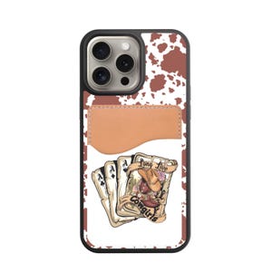 May include: A black phone case with a brown and white cowhide pattern. The case features a brown leather card holder and a graphic of playing cards with a cowgirl illustration and the text "Long Live Cowgirls."
