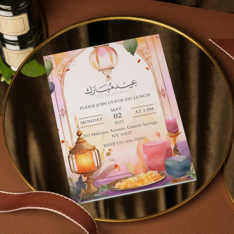 May include: An invitation card with a watercolor background featuring lanterns, flowers, and a plate of food. The text reads "Eid Mubarak" and invites guests to an Eid lunch on Monday, May 02, 2023 at 8 PM. The address is 203 Mahopac Avenue, Granite Springs, NY 10527. The RSVP number is 123-456-7890.